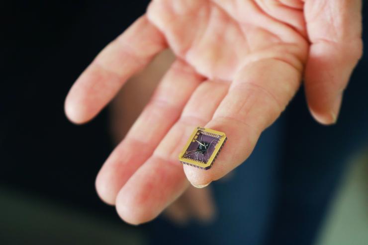 Claire Berger, physics professor at Georgia Tech, holds the team's graphene device grown on a silicon carbide substrate chip. Credit: Jess Hunt-Ralston, Georgia Tech 