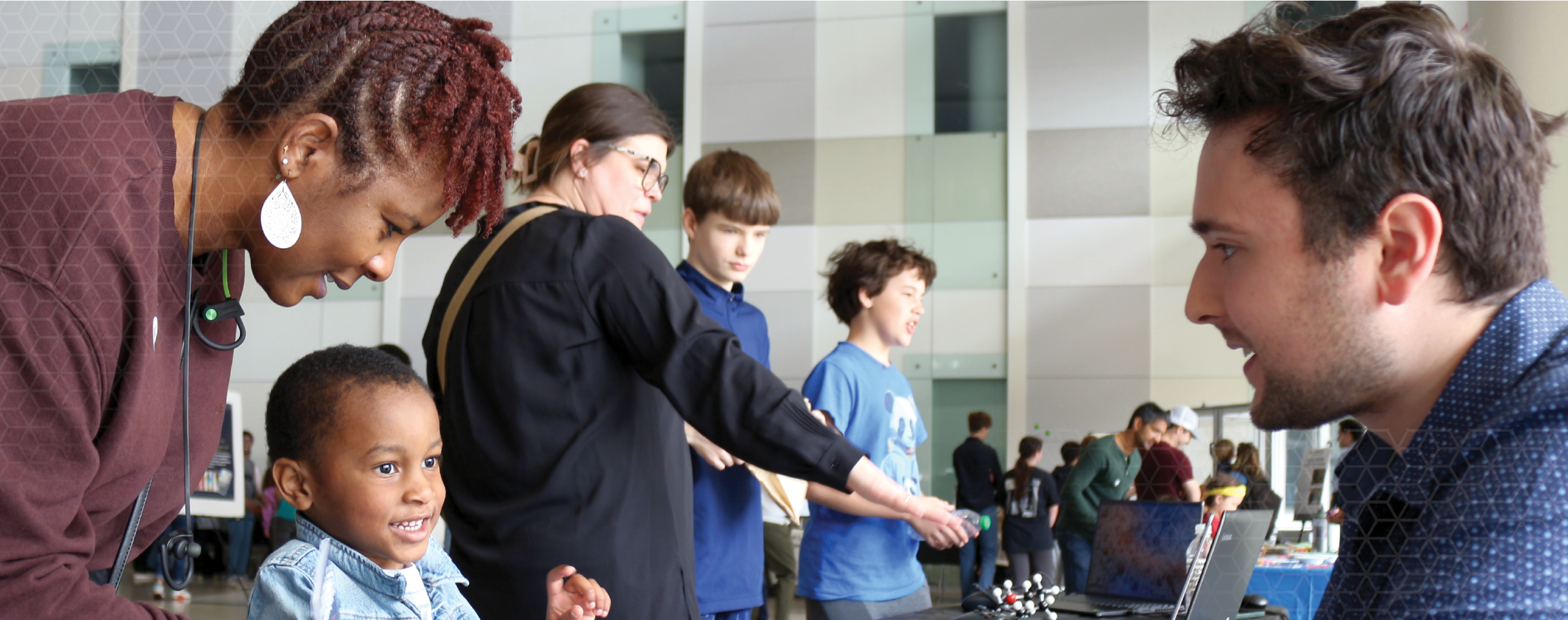 parents and children looking at demos in a large lobby