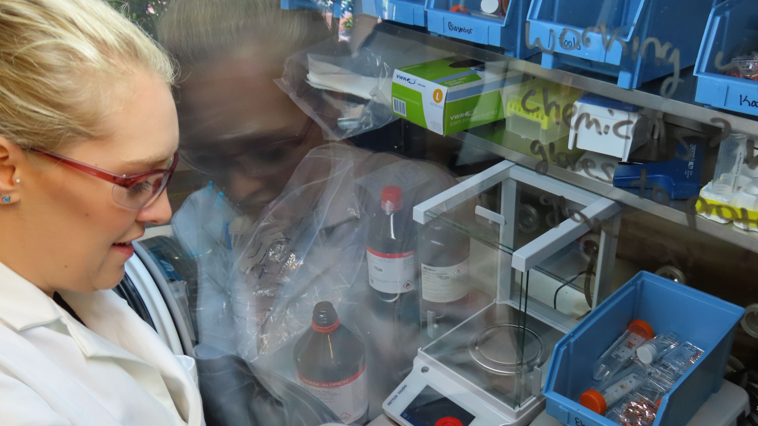 Eleanor Brightbill of The Vogel research group works in a protective glovebox in the team's lab at the Marcus Nanotechnology Building