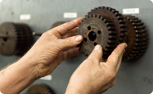 hands holding mechanical gear