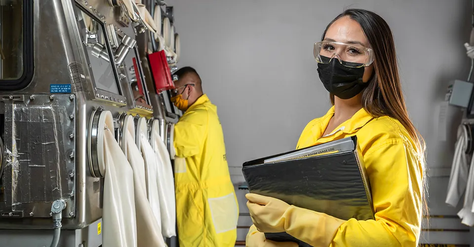 lab photo of female worker in yellow in a sophisticated laboratory setting