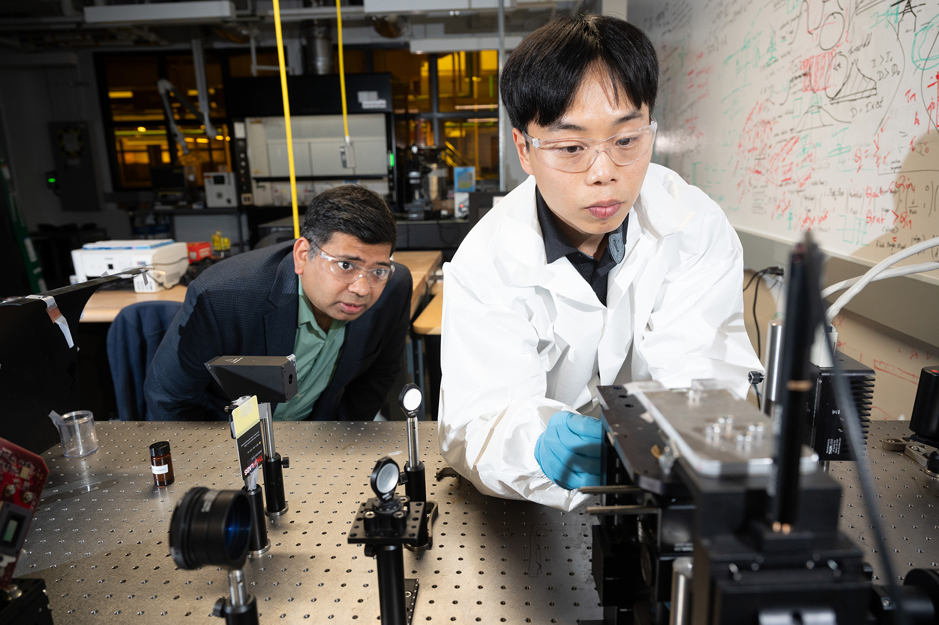A Georgia Tech professor and student working in a lab on fabrication equipment to print nano-sized metal structures