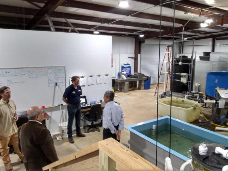 <p>(Ashok Goel (bottom left) and Sandeep Kakar (right) tour North Georgia Technical College with Environmental Technology Instructors Duncan Hughes (right) and Kevin Peyton (left) <em>Photo: AI-ALOE</em>)</p>