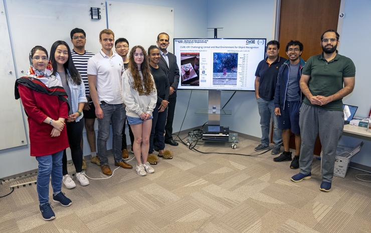 <p>Members of the OLIVES team in the lab (L-R): Ghazal Kaviani (Ph.D. candidate), Jinsol Lee (Ph.D. candidate), unknown, Ryan Benkert (Ph.D. candidate), Chen Zhou (Ph.D. candidate), Zoe Fowler (Ph.D. candidate), Yash-yee Logan (Ph.D. candidate), Professor Ghassan AlRegib, Mohit Prabhushankar (postdoctoral research fellow), Kiran Kokilepersaud (Ph.D. candidate), and Ahmad Mustafa (Ph.D. candidate).</p>
