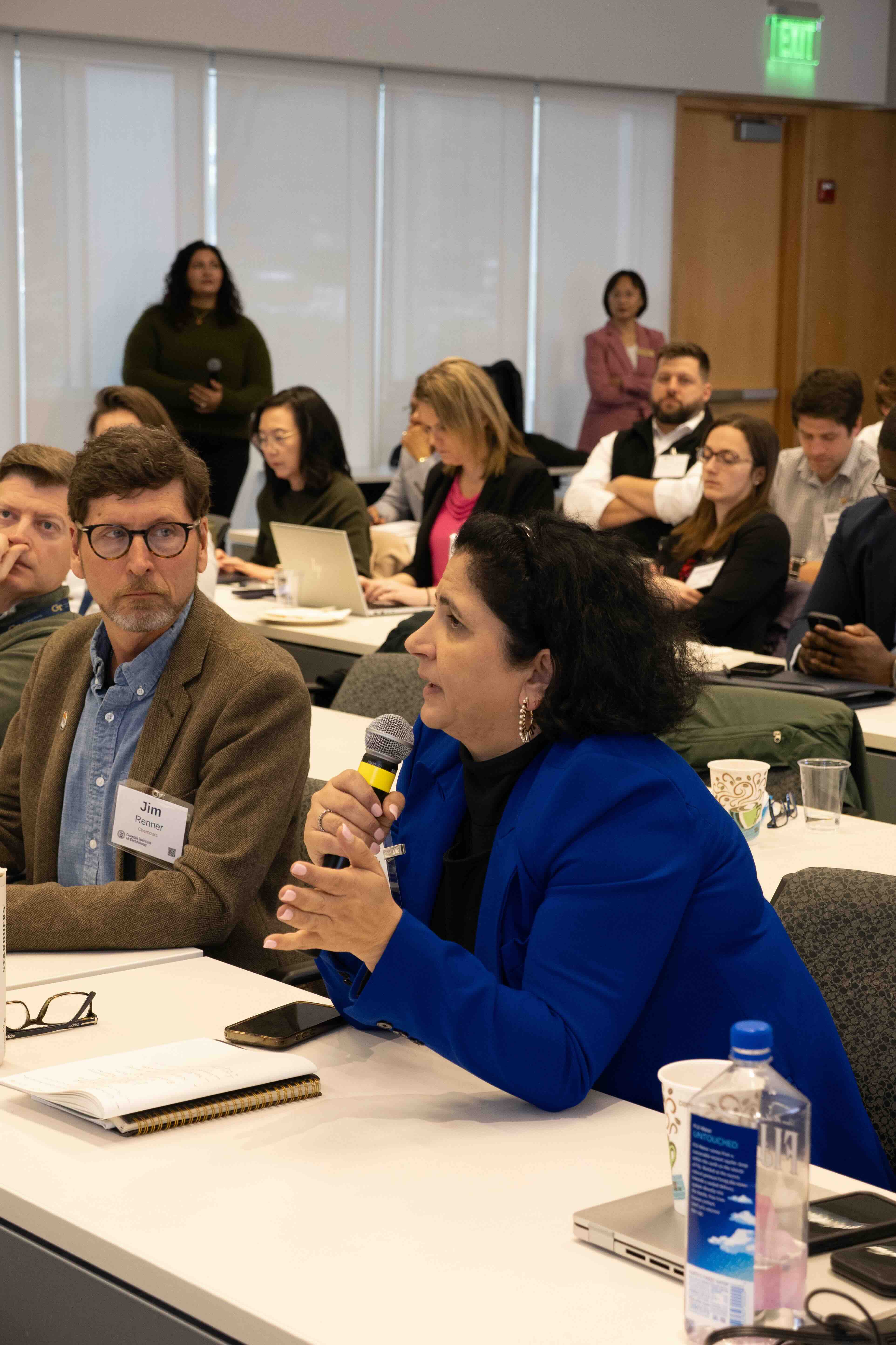 Attendee asking a question to the panel at the GEMS-4 Symposium
