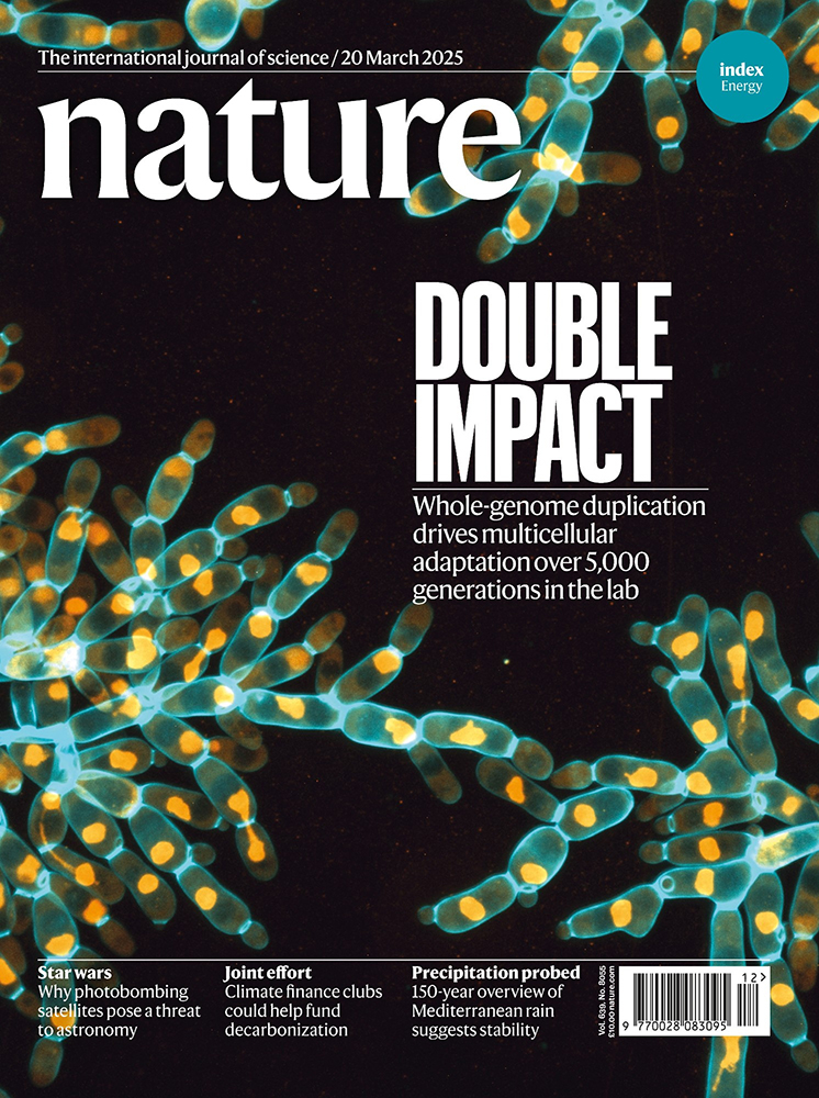 Nature magazine cover featuring yellow and cyan yeast cells on a black background