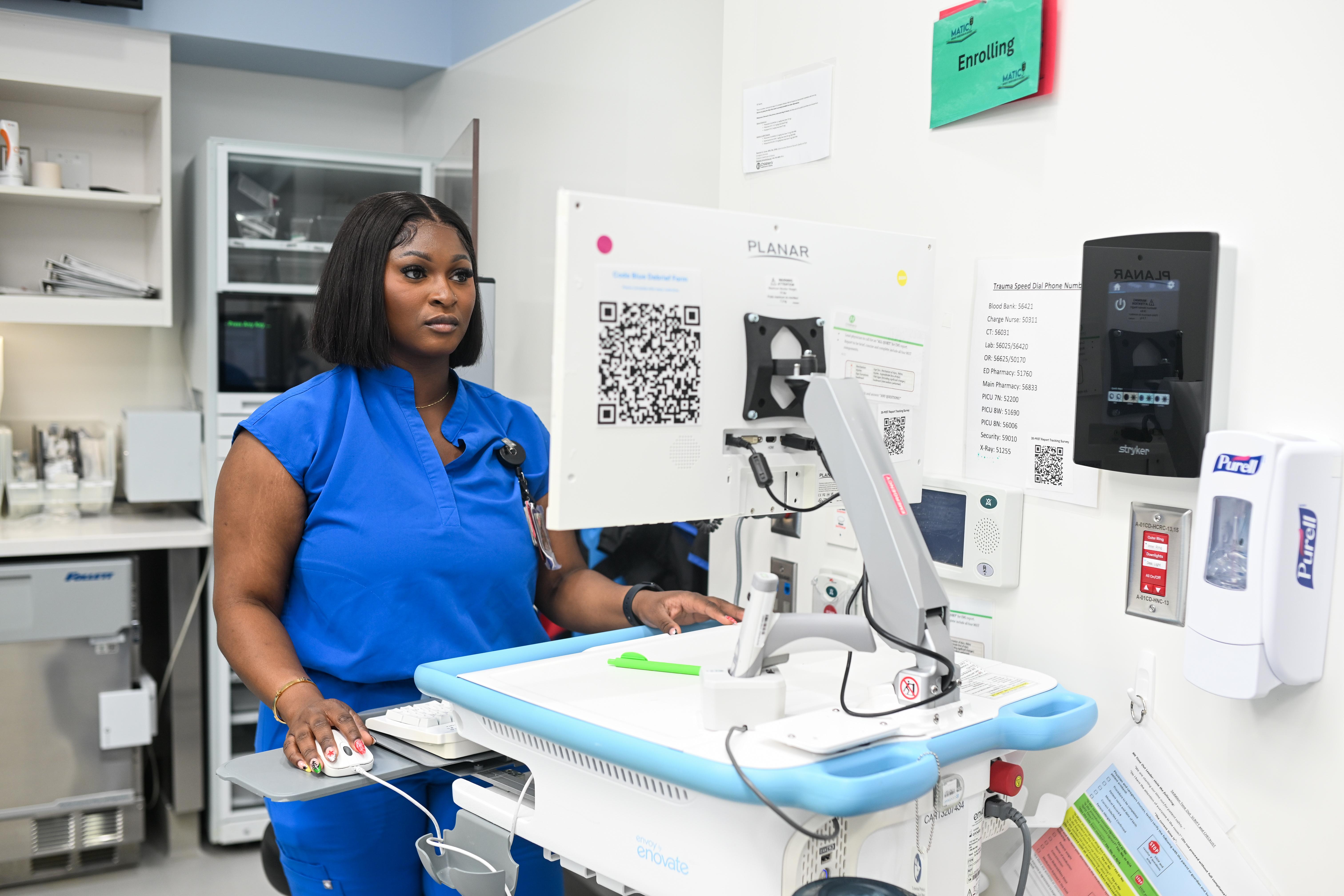 Pediatric healthcare professional reviewing electronic health record information at Children’s Healthcare of Atlanta Arthur M. Blank Hospital.