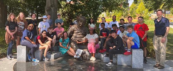 <p>Group photo of the participants of the 2022 Energy Unplugged summer camp on the Georgia Tech Atlanta campus staged around the Einstein bench statue/installation.</p>