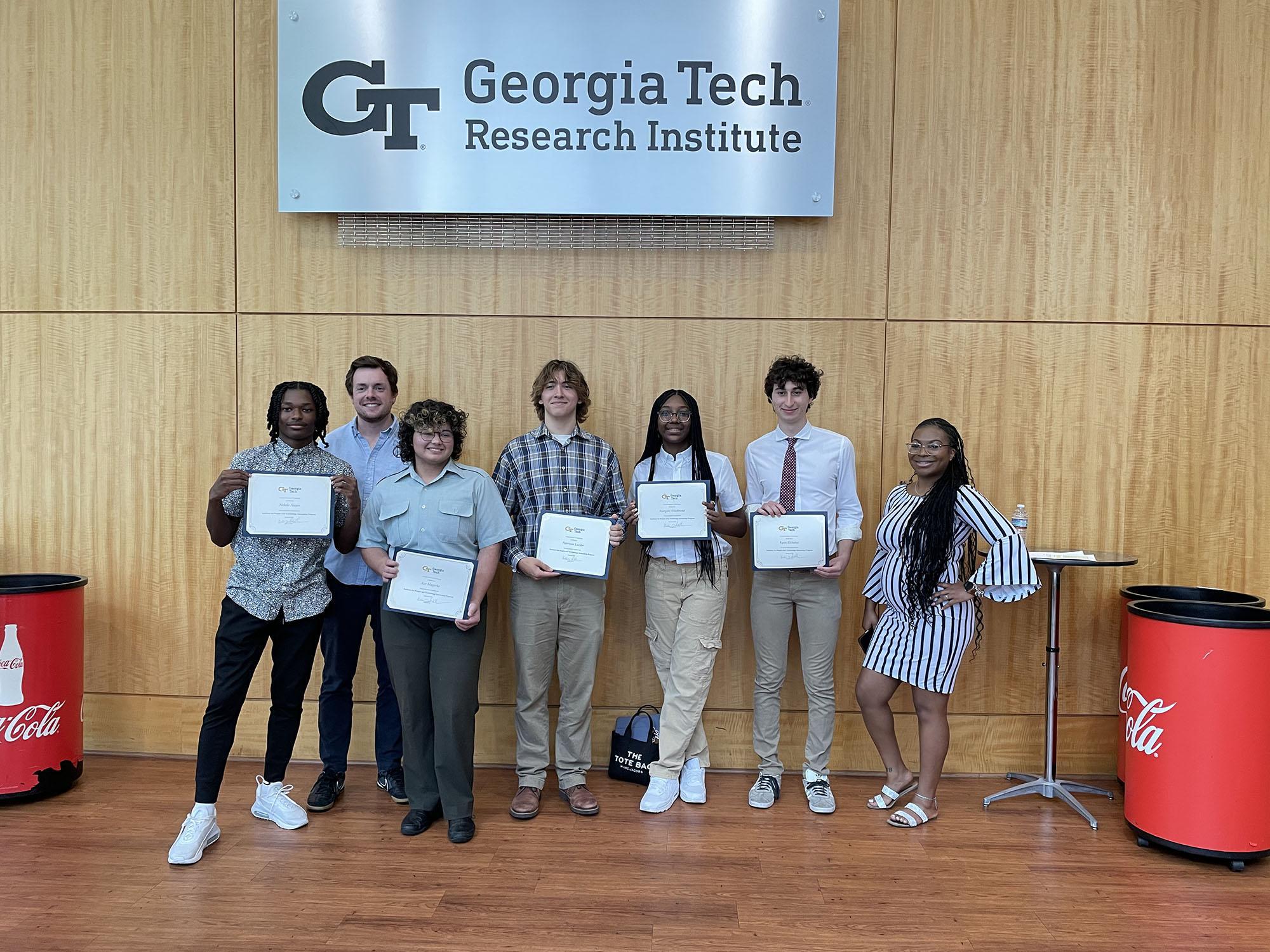 High School Students holding their internship completion certificates. Kala Jordan from IPAT pictured far right.