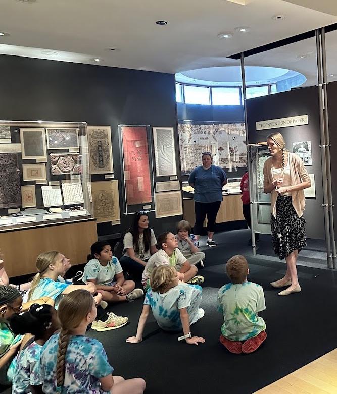 Doll giving a tour of the Robert C. Williams Museum of Papermaking to K-12 Ssudents