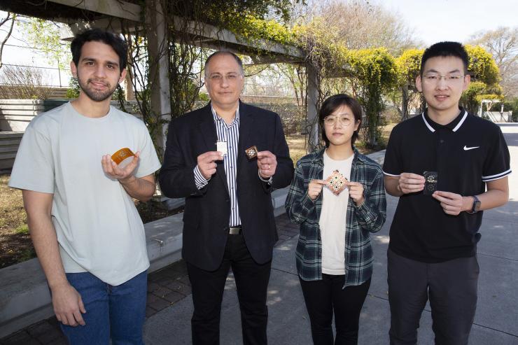 <p>Genaro Soto Valle, Manos Tentzeris<em>, </em>Kexin Hu, and Yepu Cui with the fabricated proof-of-concept tile arrays and inkjet-printed tile arrays.</p>
