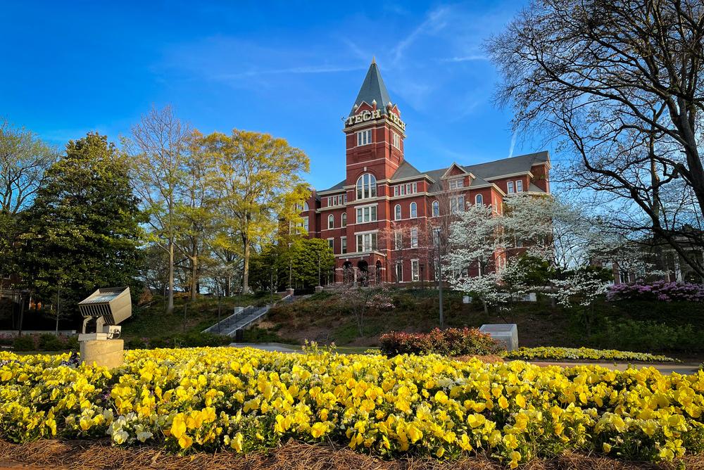 Georgia Tech's tech tower with yellow spring flowers in foreground