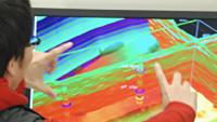 A researcher manipulates a 3-D rendering of subterranean seismic survey data.