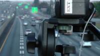 A video camera overlooks a freeway to survey traffic usage patterns.