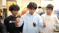 Students demonstrating an application of frugal science.
