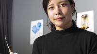 female researcher holds a sensor in a research lab at Georgia Tech
