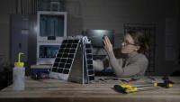 <p>Mary Kate Broadway adjusts the model's solar array. (photo: Sean McNeil)</p>