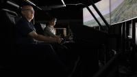 GTRI Principal Research Engineer Eric Grigorian (left) leads a flight simulator presentation at GTRI's Huntsville Research Center