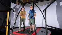 <p>Pawel Golyski and Associate Professor of Mechanical Engineering Gregory Sawicki (left) with the CAREN (Computer Assisted Rehabilitation Environment) system at Georgia Tech's EPIC Lab.  </p>