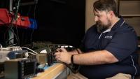 GTRI Senior Research Engineer Scott Tompkins is shown reconfiguring an Air Ground Networking Radio (AGNR) for testing