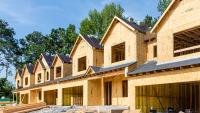 A row of attached homes under construction