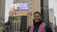 Jerushia Graham in front of her digital billboard in downtown Atlanta. 