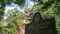Georgia Tech's historic campus signage is shown, with Tech Tower in the background.