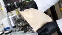 Two hands holding an example of the DUCKY polymer membranes researchers created to perform the initial separation of crude oils with significantly less energy. (Photo: Candler Hobbs)