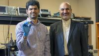 <p>ECE professor Ali Adibi with Ph.D. candidate Sajjad Abdollahramezani holding their packaged tunable metasurface device.</p>