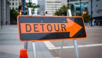 A detour sign on a street