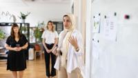 Woman gives presentation to colleagues