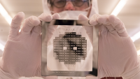 Cleanroom staff holding a wafer