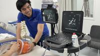 Cassidy Wang interacting with a physician who is testing Ethos' needle guidance system.