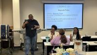 Mikkel Thomas speakers with K-12 Educators during a summer training