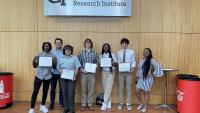 High School Students holding their internship completion certificates. Kala Jordan from IPAT pictured far right.