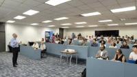 Pascal in Panama lecturing in front of a large group of seated students.