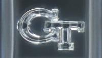a 3D printed silica glass "GT" logo