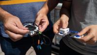 <p>Close-up view of Omer Inan and Samer Mabrouk holding prototypes of their new sensor</p>
