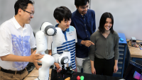 l-r: Professor Ye Zhao, high school intern Matthew Zhu, graduate student Chaitanya Mehta, and high school intern Christian Hable with the lab's robotic arm with tactile sensors