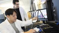 <p>Associate Professor Costas Arvanitis and mechanical engineering Ph.D. student Hohyun "Henry" Lee with their closed-loop controlled focused ultrasound system. The uses ultrasound-induced microbubbles to help a powerful immunotherapy target brain tumors and a custom algorithm to continuously fine tune the bubbles for maximum impact.</p>
