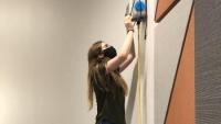 <p>ChBE PhD student Sabrina Westgate installs an air sensor to monitor classroom air quality.</p>