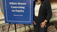 Donna Ennis next to poster board