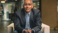 Professor Karthik Ramachandran sits in a chair with his hands clasped