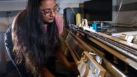 Former Matsumoto Group member Krishma Singal operates a knitting machine used to create fabric samples for a previous study. Singal recently graduated from Georgia Tech with her Ph.D. (Photo Credit: Allison Carter)