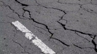 Streets crack under heat because higher temperatures create more space between vibrating molecules, causing the material to expand and deform. Priscila Zambotto/Moment via Getty Images