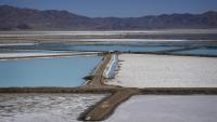 A truck is parked betwenn brine evaporation ponds at Albemarle Corp's Silver Peak lithium facility, Oct 6, 2022, in Silver Peeak, Nev. The Energy Department is making a push to strenghten the U.S. battery supply chain, announcing Wednesday, Nov 15, 2023, up to $3.5 billion for companies that produce batteries and the critical minerals that go into them. (AP Photo/John Locher, File)
