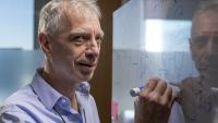 Pascal Van Hentenryck writing on a white board