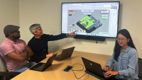 Pictured: Interactive PhD students Glen Smith (far left) and Qiao Zhang (far right) working with Assistant Professor Christopher MacLellan on the Dice Adventure game. 