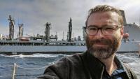 <p>A Shelby Allen selfie taken during resupply activities onboard the U.S.S. Rafael Peralta, a guided missile destroyer where GTRI researchers evaluated the Bifrost system. (Credit: Shelby Allen, GTRI)</p>