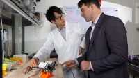 Trenton Gantt and Hugh (Ka Yui) Chen work together in the lab